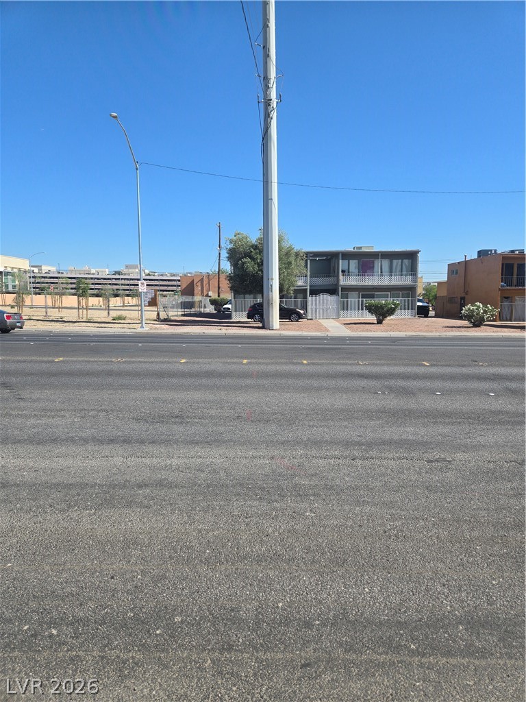 1388 East Desert Inn Road, Unit 2 Las Vegas, NV 89169 - Photo 22 of 23 Observe this urban street scene, highlighting the architectural style of nearby structures and clear sky above.