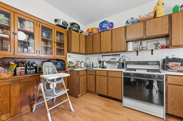 a kitchen with stainless steel appliances granite countertop a stove and cabinets