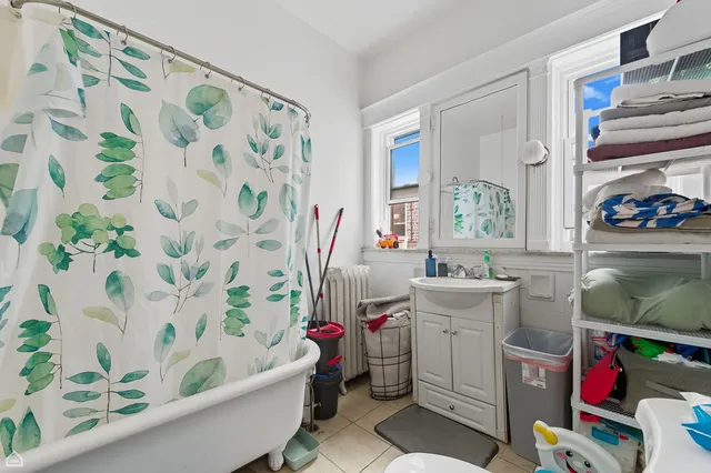 a bathroom with a sink a toilet and a shower curtain