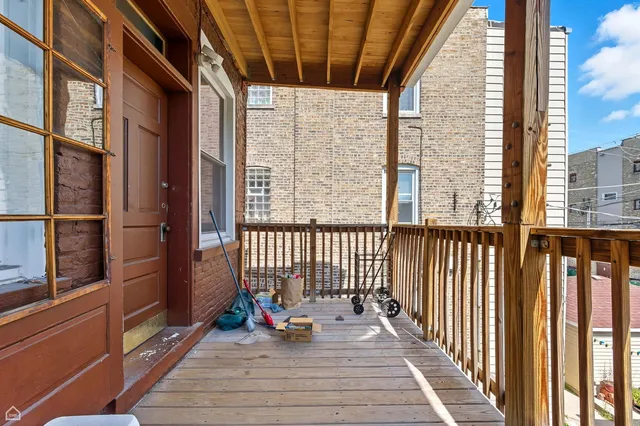 a view of a balcony with wooden floor