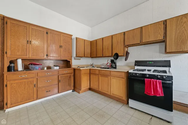 a kitchen with stainless steel appliances granite countertop a stove sink and cabinets