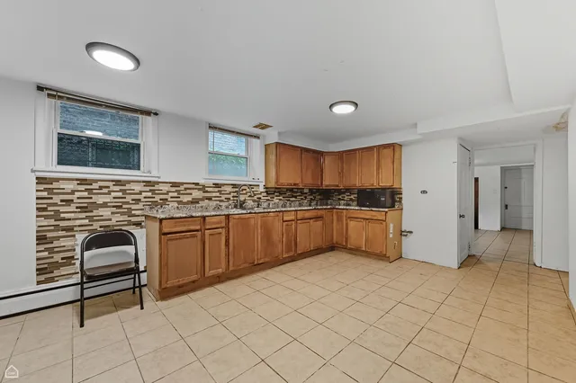a kitchen with granite countertop a sink and cabinets