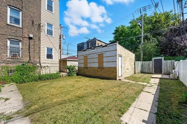 a view of a house with a yard and potted plants