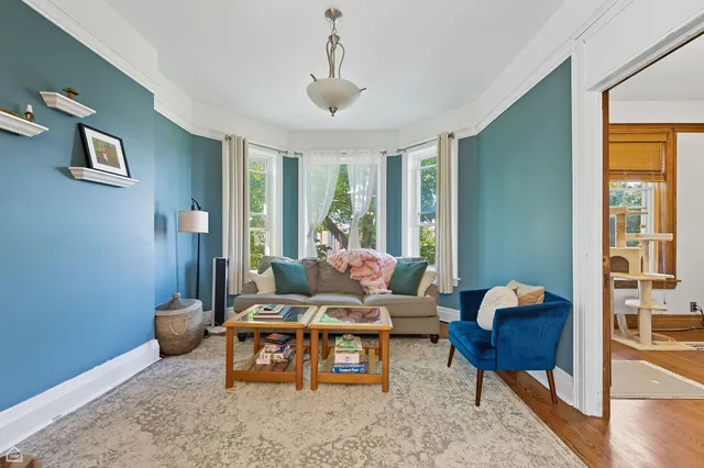 a living room with furniture and a potted plant