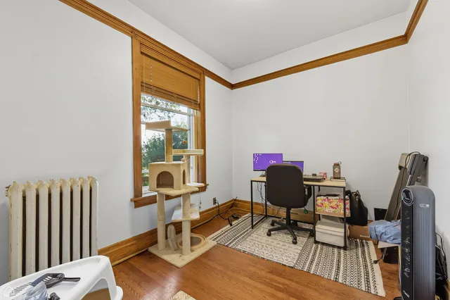 a view of a workspace with furniture and wooden floor