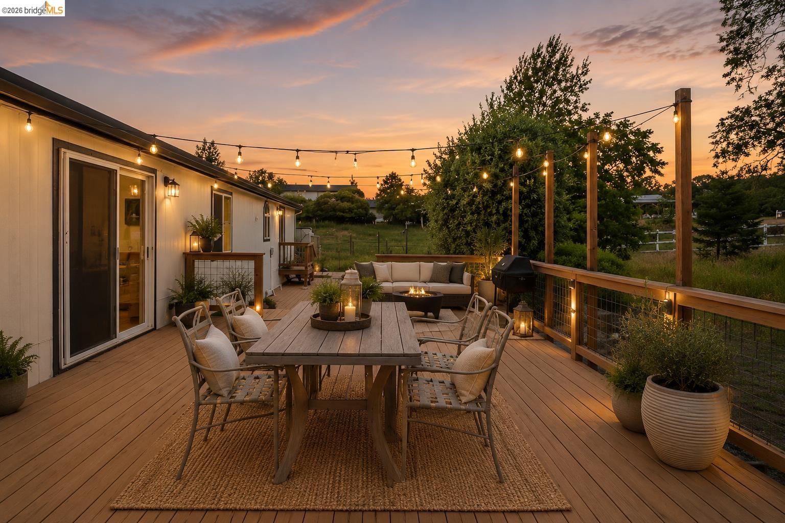 4419 Little John Road Copperopolis, CA 95228 - Photo 24 of 43 Expansive outdoor deck featuring wood-finish flooring, string lights, and a wood railing with wire infill