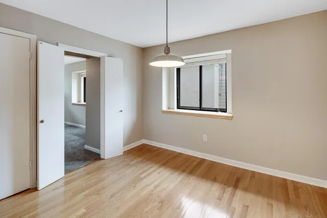 a view of a kitchen with a refrigerator and a stove top oven