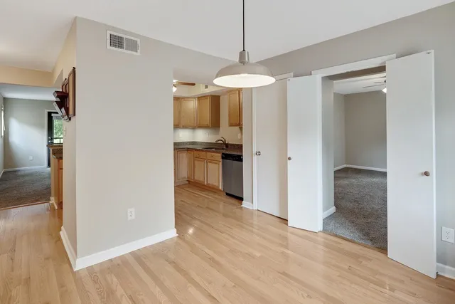 an empty room with windows and fireplace
