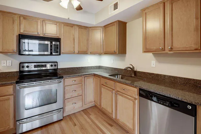 a kitchen with a stove top oven sink and cabinets