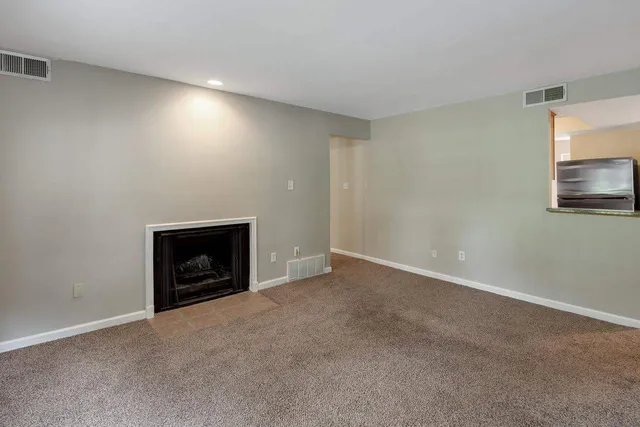 a view of an empty room with a fireplace