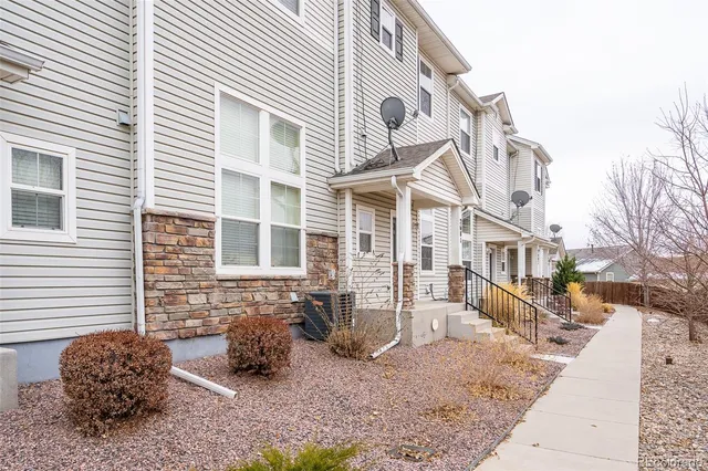 a view of a brick house with many windows