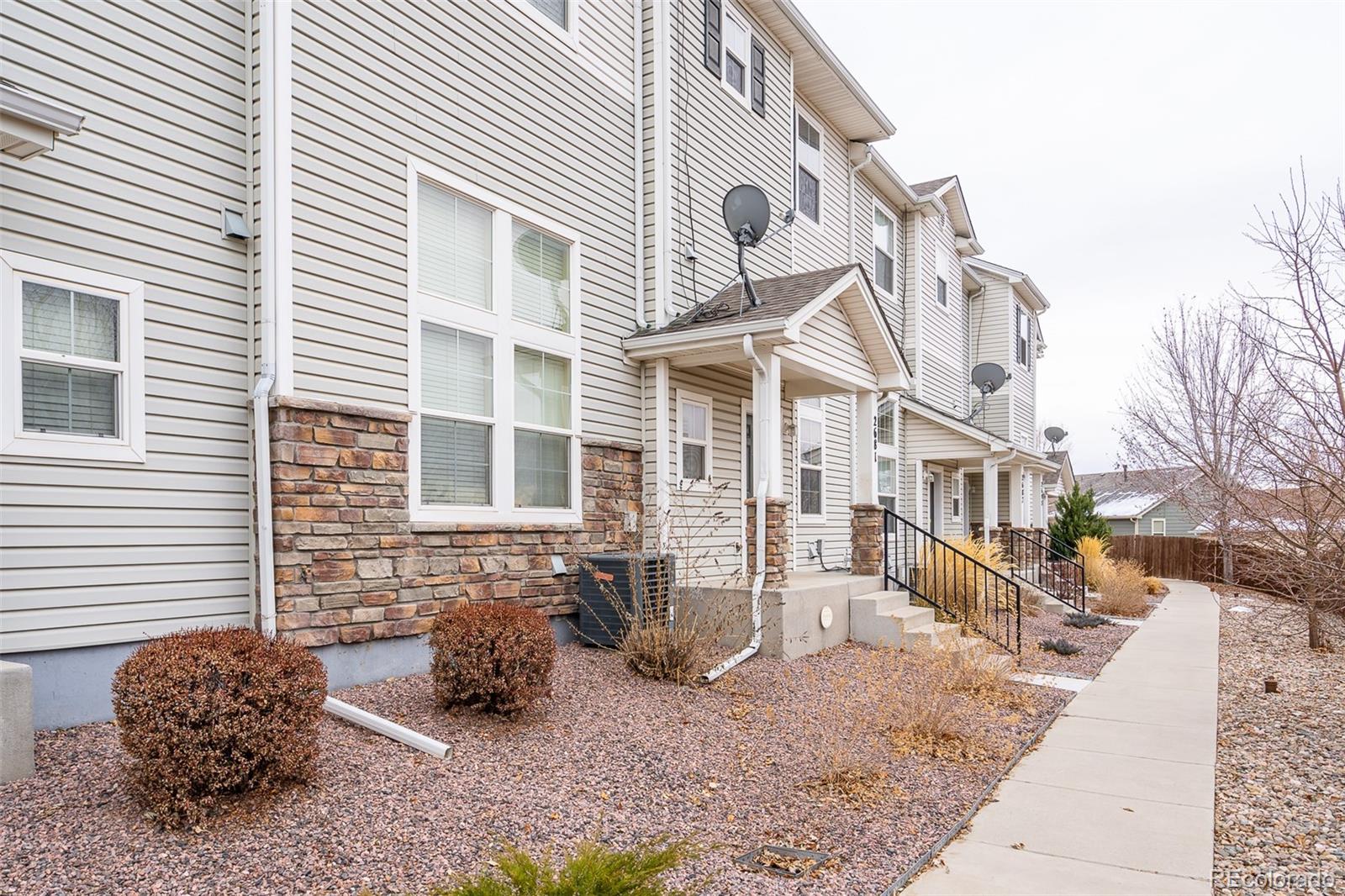a view of a brick house with many windows