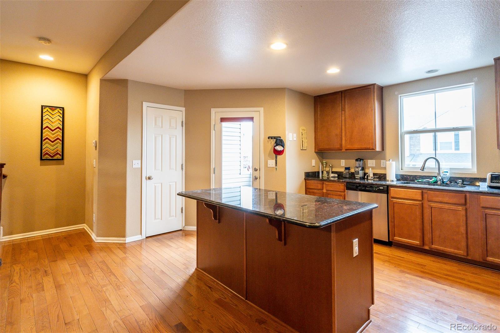 2681 Stonecrop Ridge Grove Colorado Springs, CO 80910 - Photo 13 of 26 a kitchen with stainless steel appliances granite countertop a sink dishwasher a stove and a refrigerator