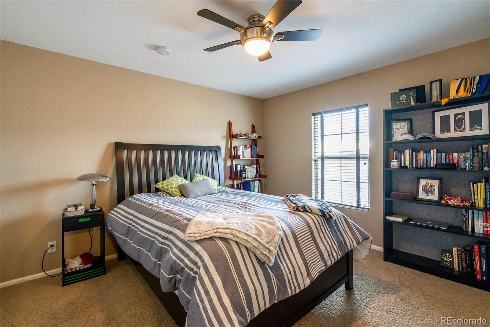 2681 Stonecrop Ridge Grove Colorado Springs, CO 80910 - Photo 17 of 26 a bedroom with bed and a book shelf