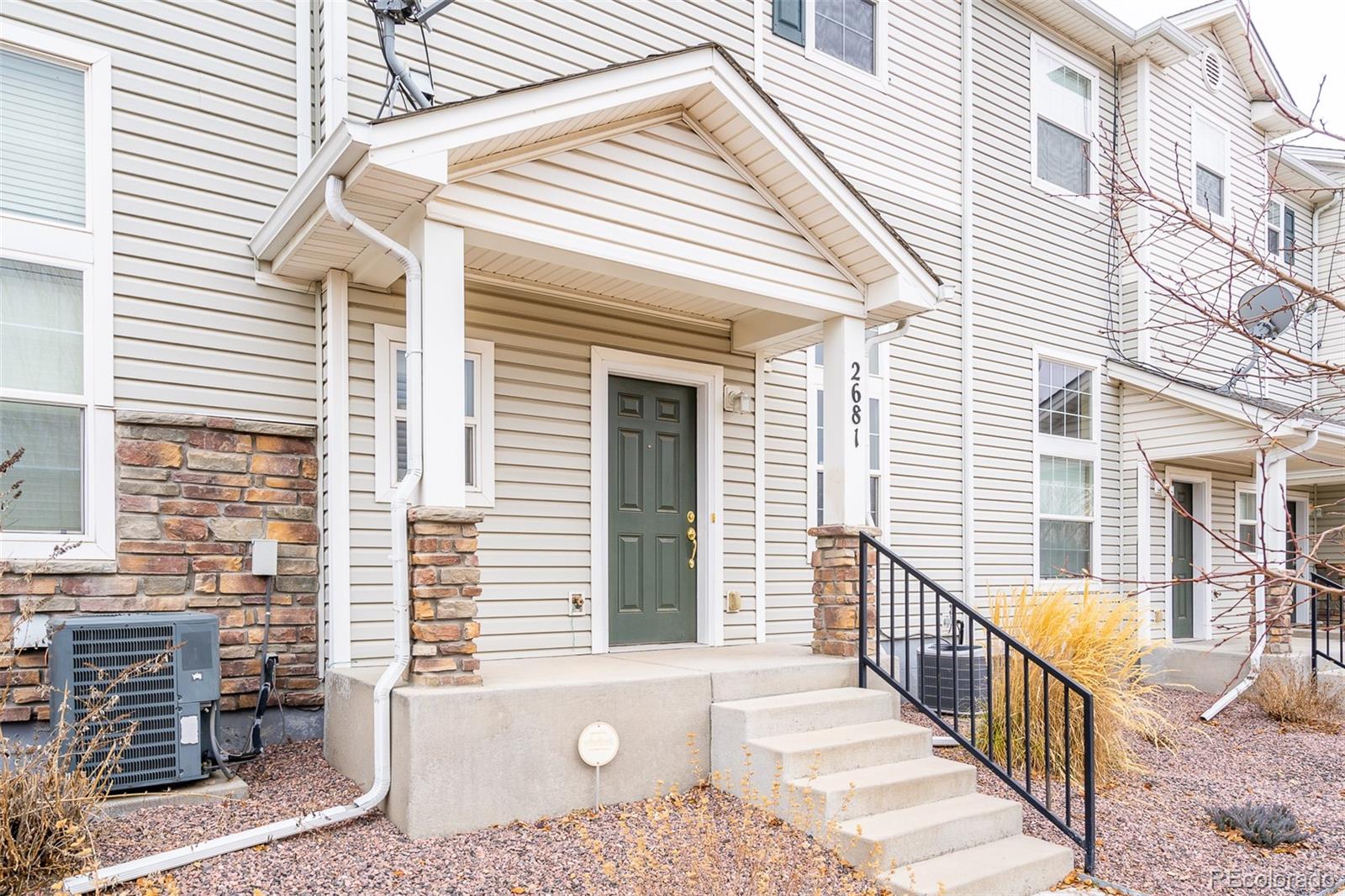 2681 Stonecrop Ridge Grove Colorado Springs, CO 80910 - Photo 2 of 26 a view of balcony with two chairs and potted plants