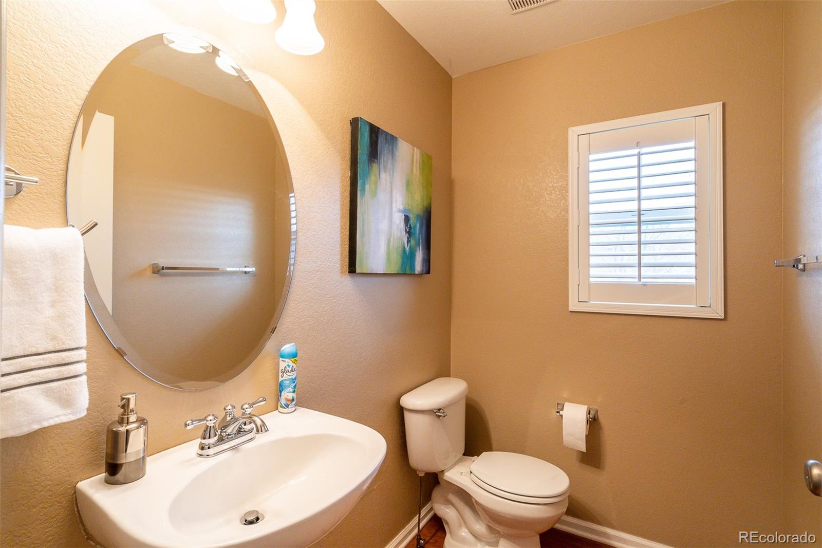2681 Stonecrop Ridge Grove Colorado Springs, CO 80910 - Photo 8 of 26 a bathroom with a toilet sink and mirror