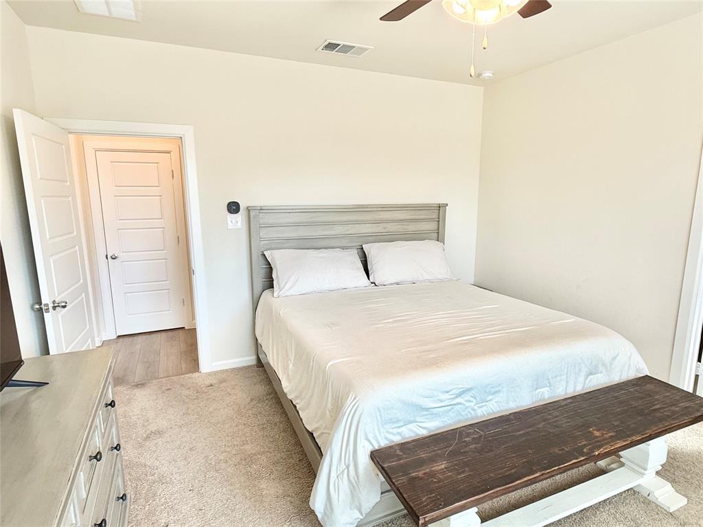 603 Hazeltine Road Red Oak, TX 75154 - Photo 17 of 37 a bedroom with a bed and a window