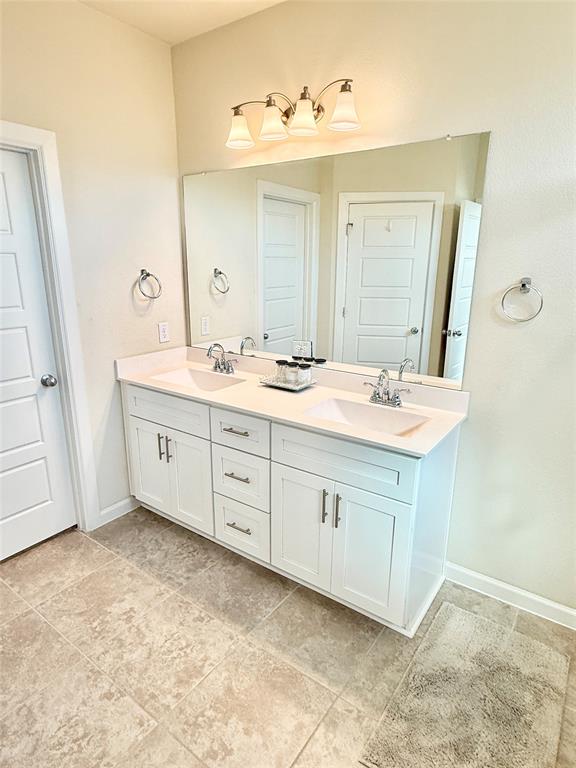 603 Hazeltine Road Red Oak, TX 75154 - Photo 20 of 37 a bathroom with a double vanity sink and mirror