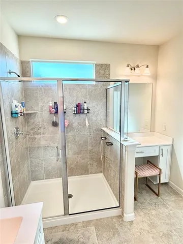 a bathroom with a shower and a sink