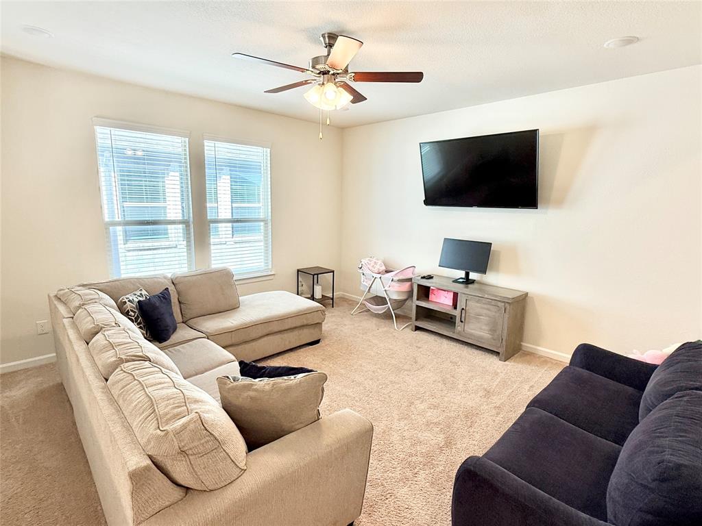 603 Hazeltine Road Red Oak, TX 75154 - Photo 26 of 37 a living room with furniture and a flat screen tv