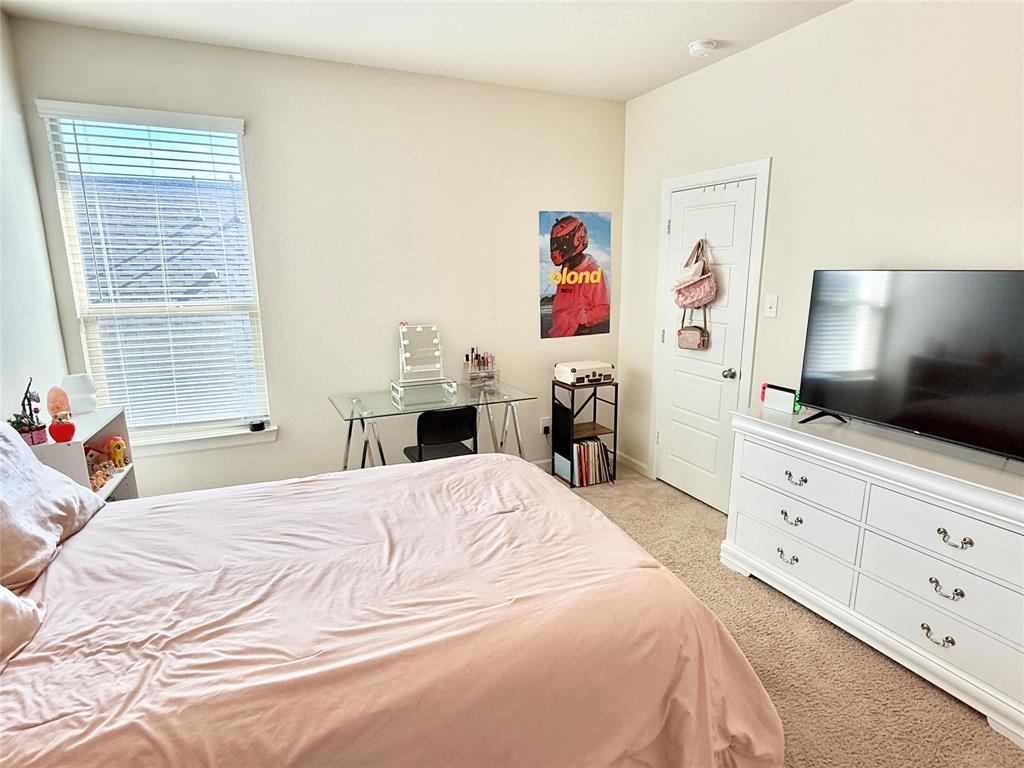 603 Hazeltine Road Red Oak, TX 75154 - Photo 28 of 37 a bedroom with a bed and a flat screen tv