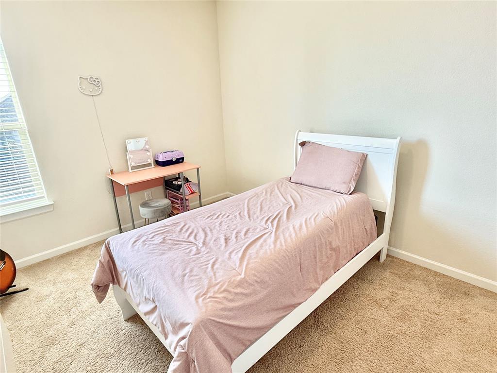 603 Hazeltine Road Red Oak, TX 75154 - Photo 29 of 37 a large bed sitting in a bedroom next to a window