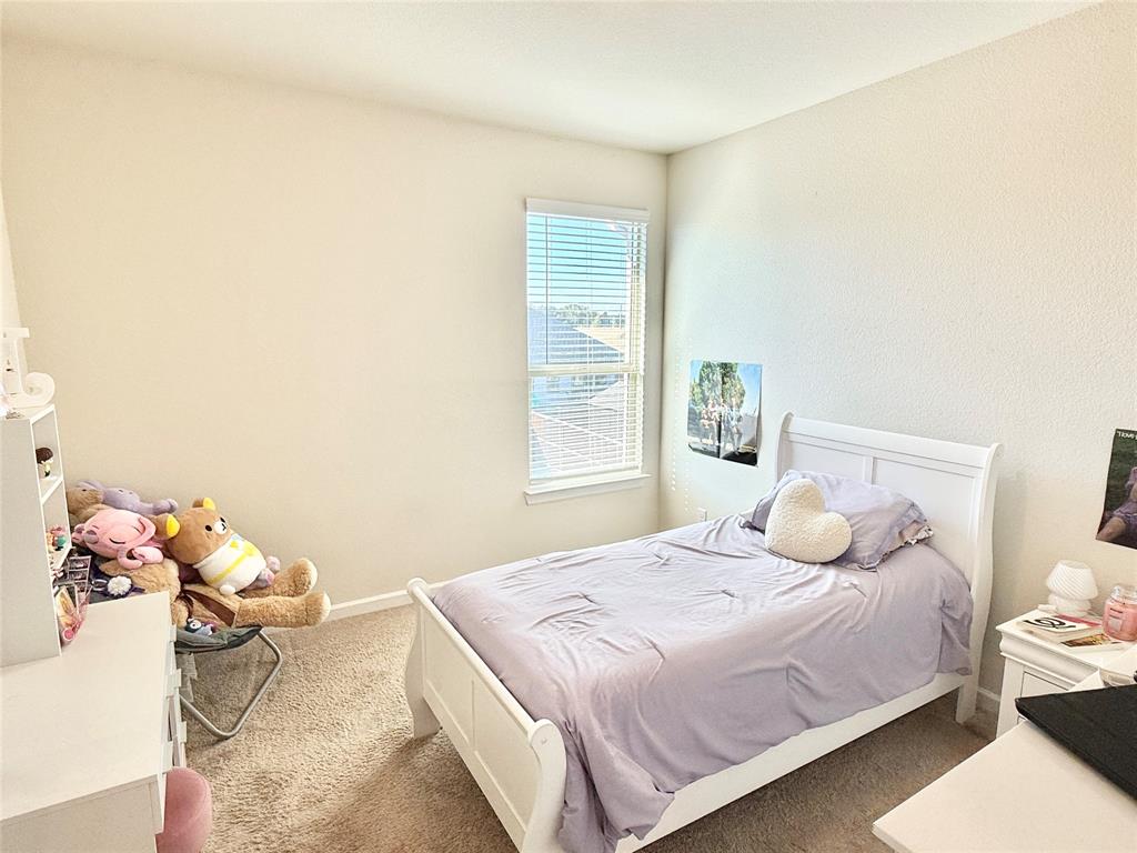 603 Hazeltine Road Red Oak, TX 75154 - Photo 31 of 37 a bedroom with a bed and window