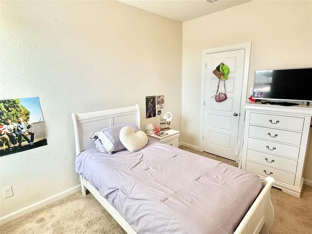 a bedroom with a bed and flat screen tv