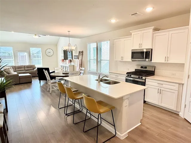 a kitchen with a stove a sink and a refrigerator