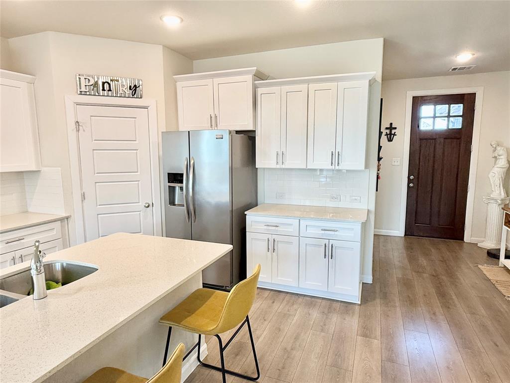 603 Hazeltine Road Red Oak, TX 75154 - Photo 10 of 37 a kitchen with stainless steel appliances a refrigerator sink and cabinets