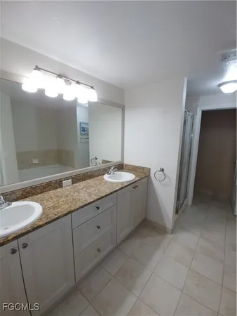 a bathroom with a granite countertop sink a mirror and a