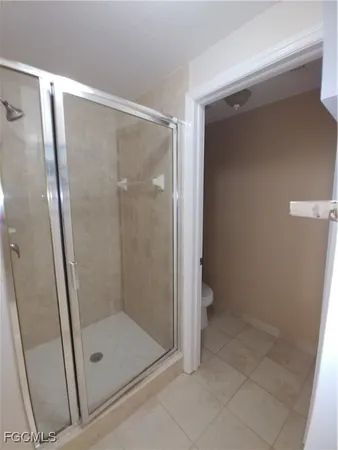 a bathroom with a glass door shower