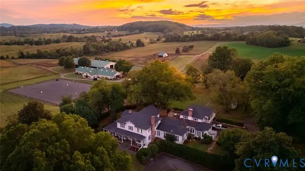an aerial view of residential houses with outdoor space and river