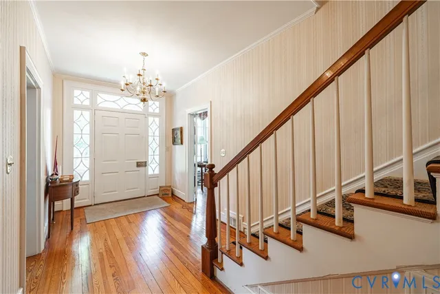 a view of an entryway wooden floor and stairs