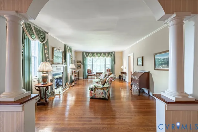 a living room with fireplace furniture and a wooden floor