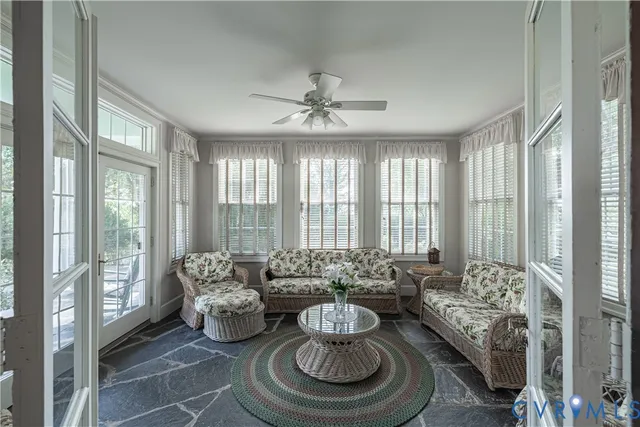 a living room with furniture and a floor to ceiling window