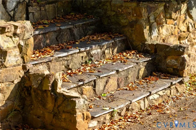 a view of a house with a yard and potted plants