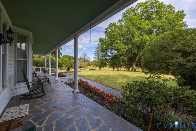 a view of a swimming pool with chairs in patio