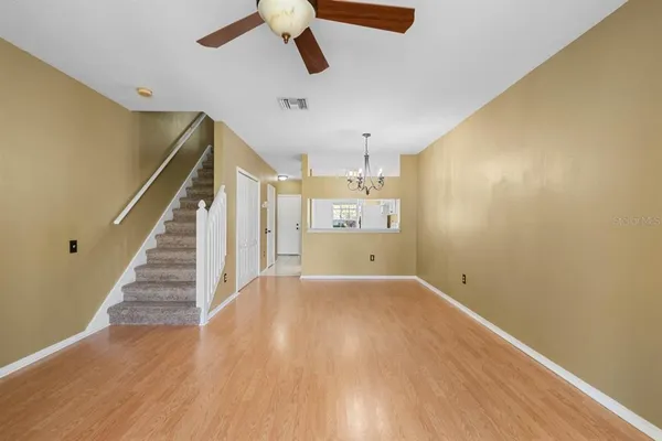 a view of a room with wooden floor and staircase