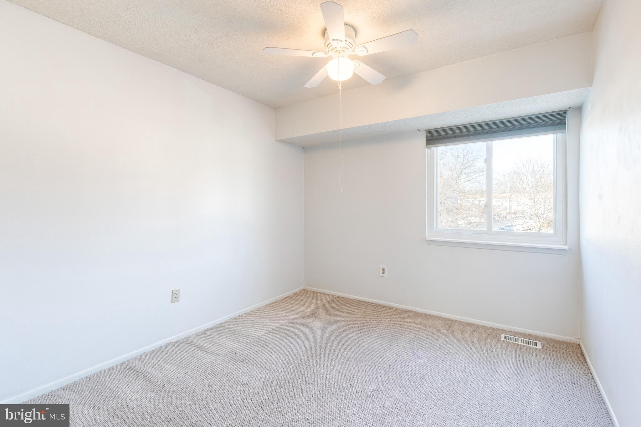 1615 Fendall Court Crofton, MD 21114 - Photo 11 of 16 an empty room with a window and a fan