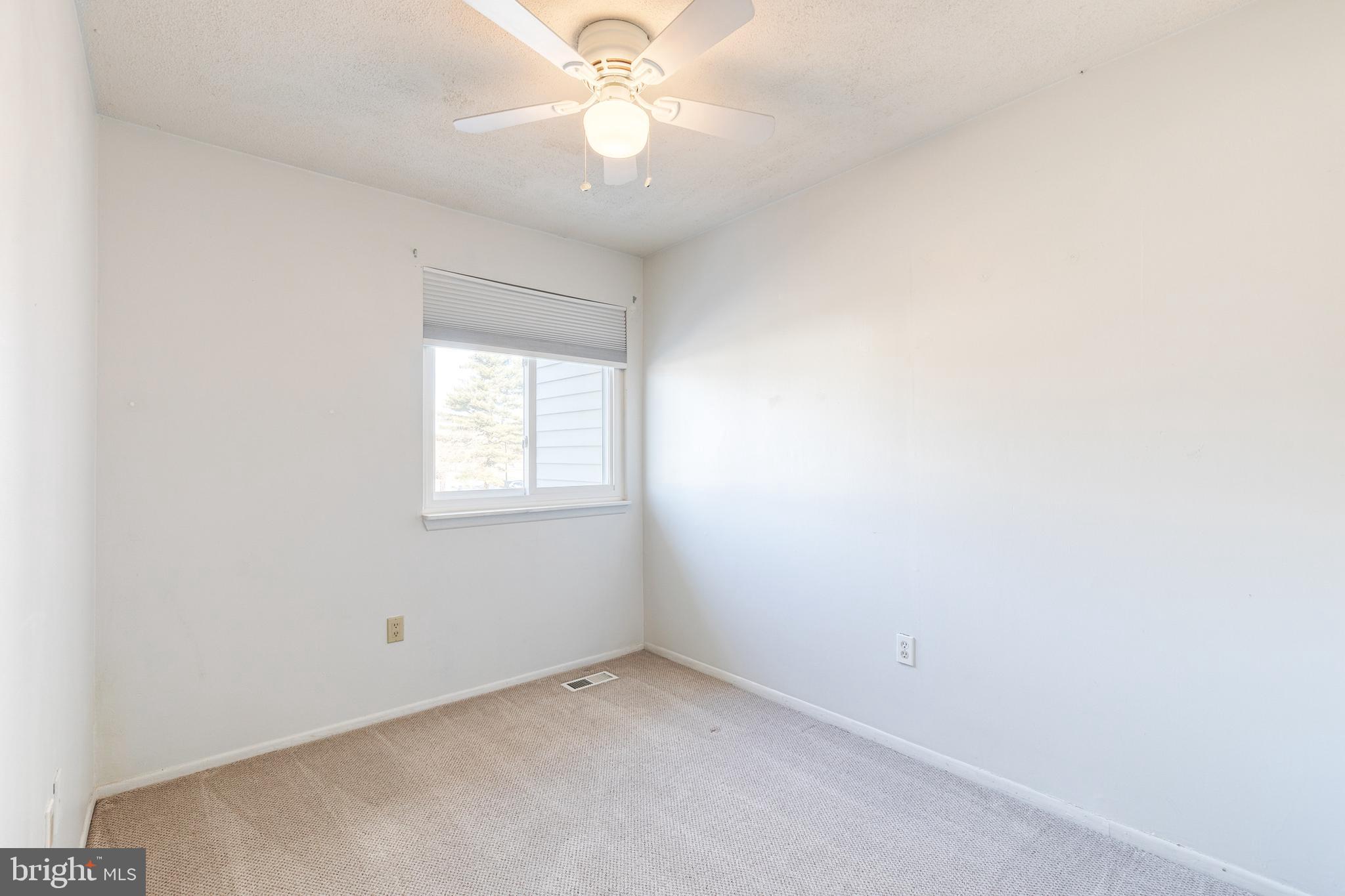 1615 Fendall Court Crofton, MD 21114 - Photo 12 of 16 an empty room with a window and a fan