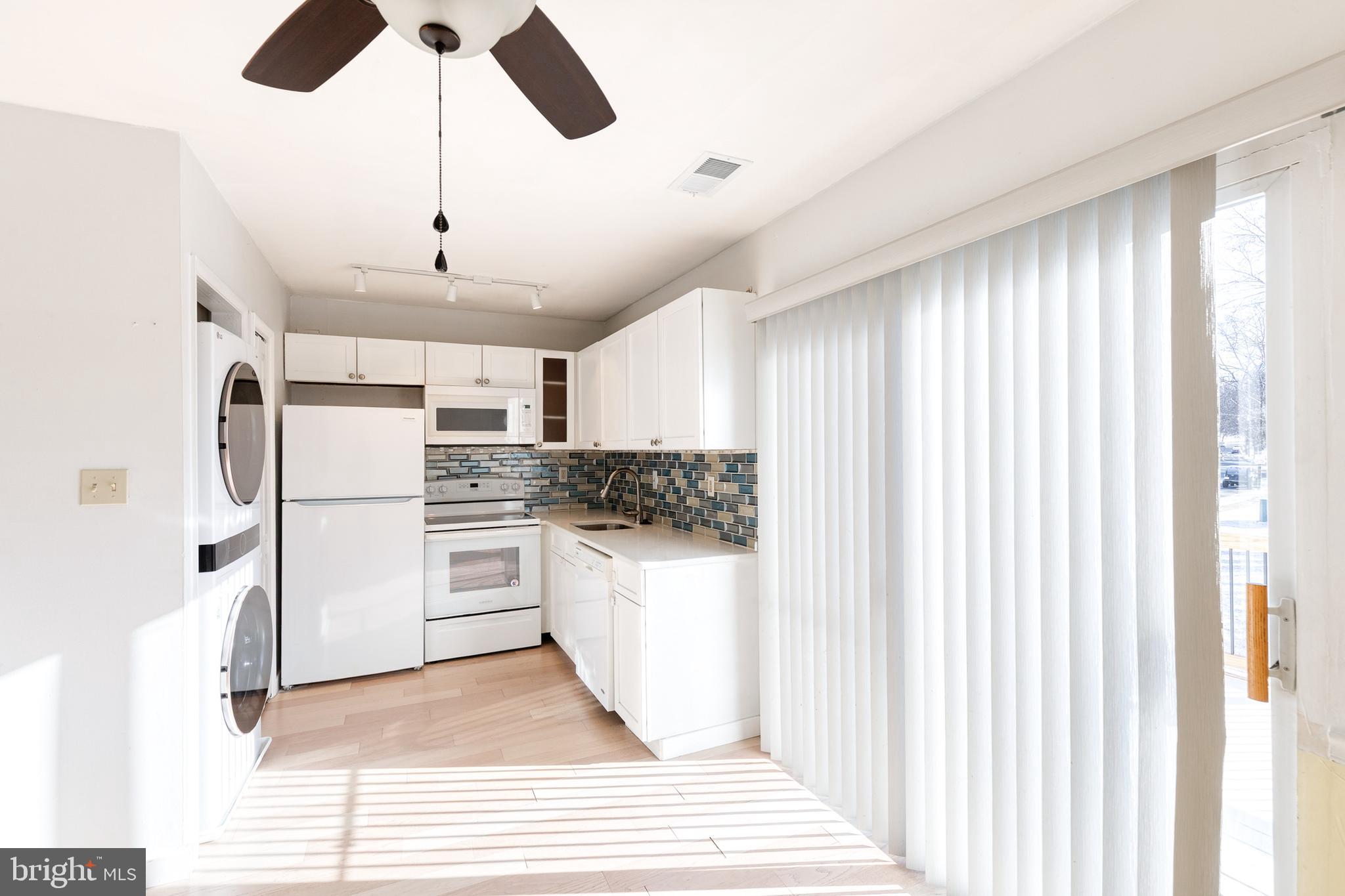 1615 Fendall Court Crofton, MD 21114 - Photo 6 of 16 a kitchen with white cabinets and white appliances