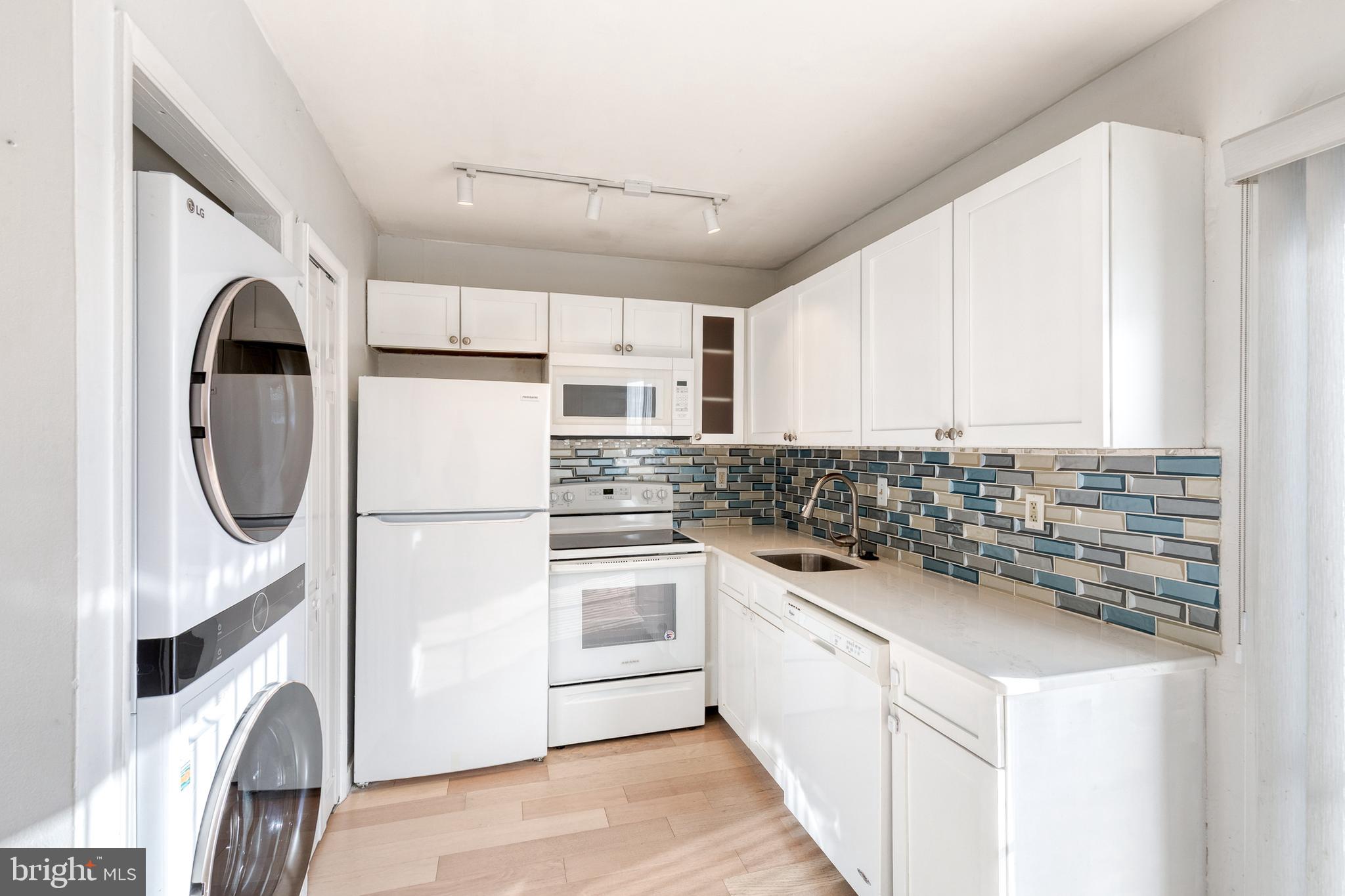 1615 Fendall Court Crofton, MD 21114 - Photo 7 of 16 a kitchen with a white cabinets stove and white stainless steel appliances