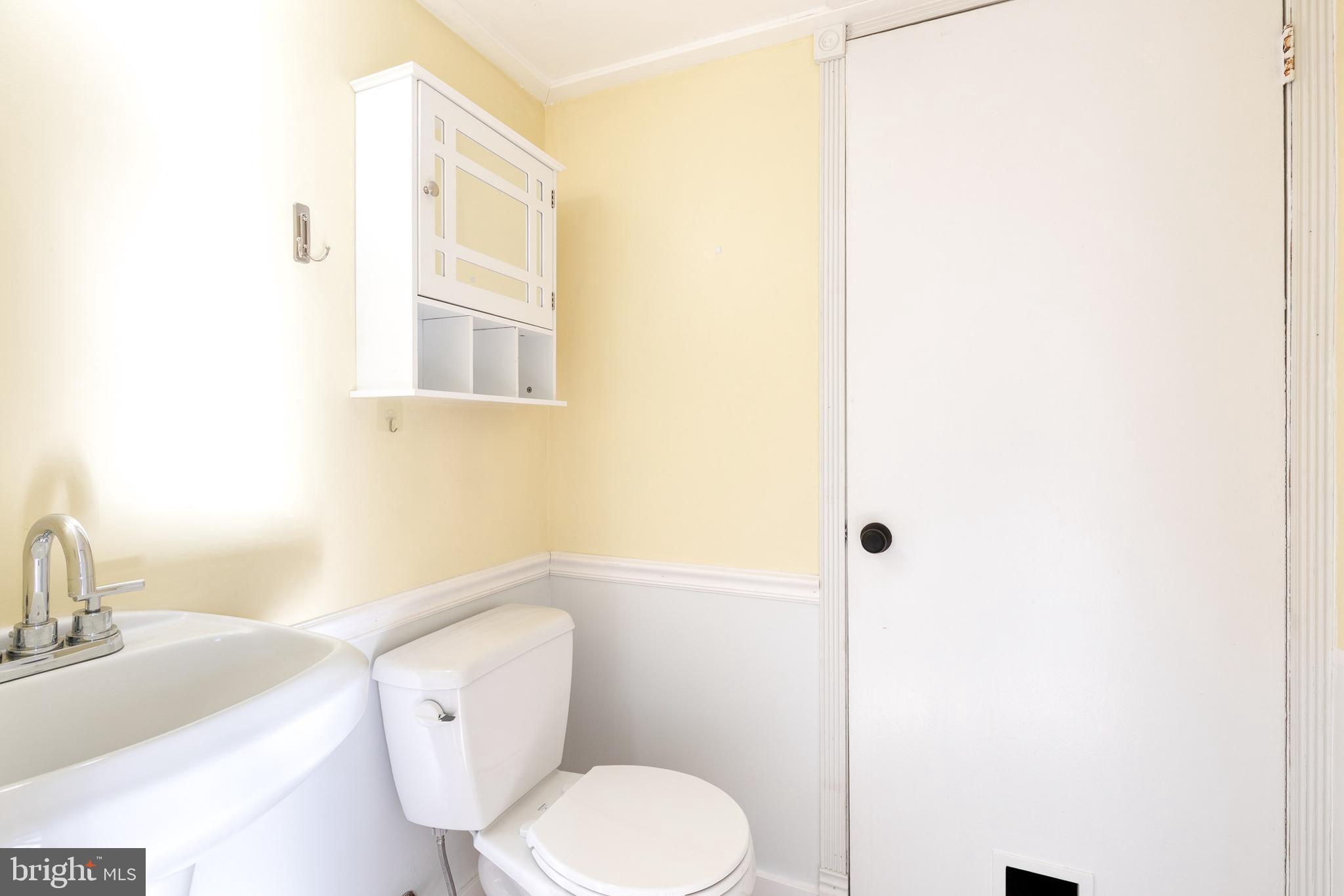 1615 Fendall Court Crofton, MD 21114 - Photo 10 of 16 a white toilet sitting next to a bathroom sink