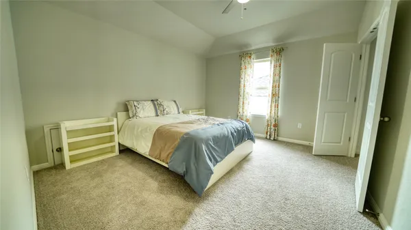 an empty room with a window and a ceiling fan
