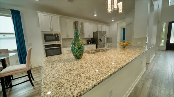 a living room with furniture and a view of kitchen