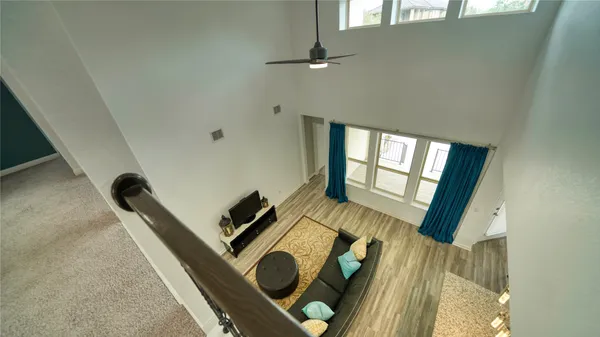a view of a hallway with wooden floor and entryway