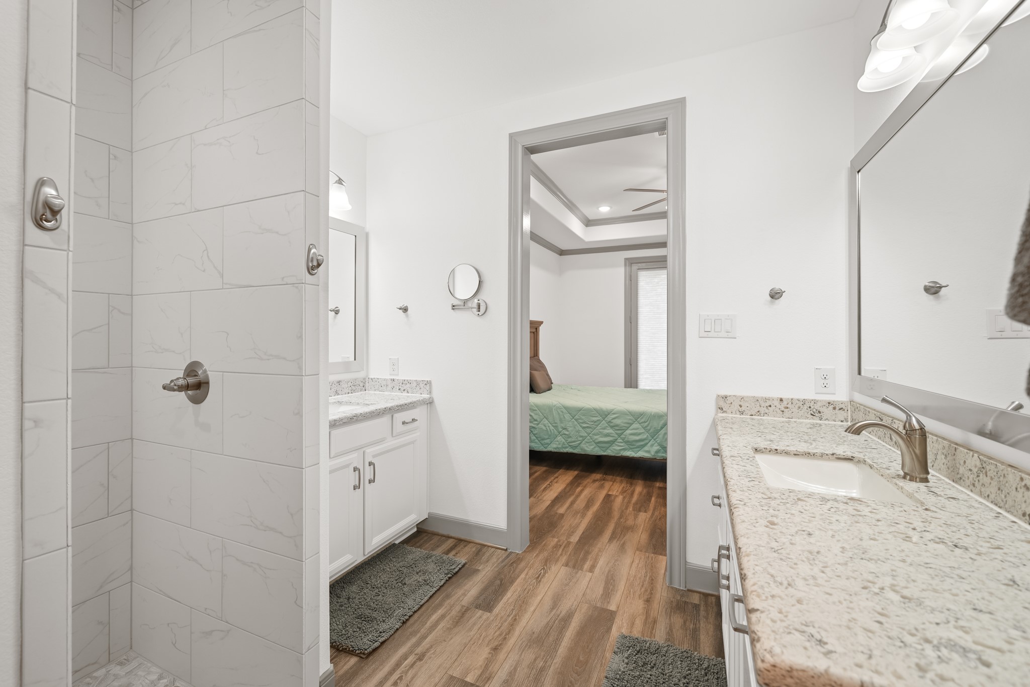 5739 Bobwhite Trail Manvel, TX 77578 - Photo 17 of 29 Dual vanities with granite countertops provide generous space for busy mornings, while the open layout creates a bright, luxurious feel. The private primary suite is designed with both style and function in mind.