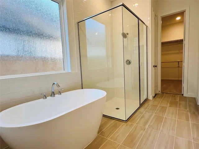 a bathroom with a bathtub and a shower