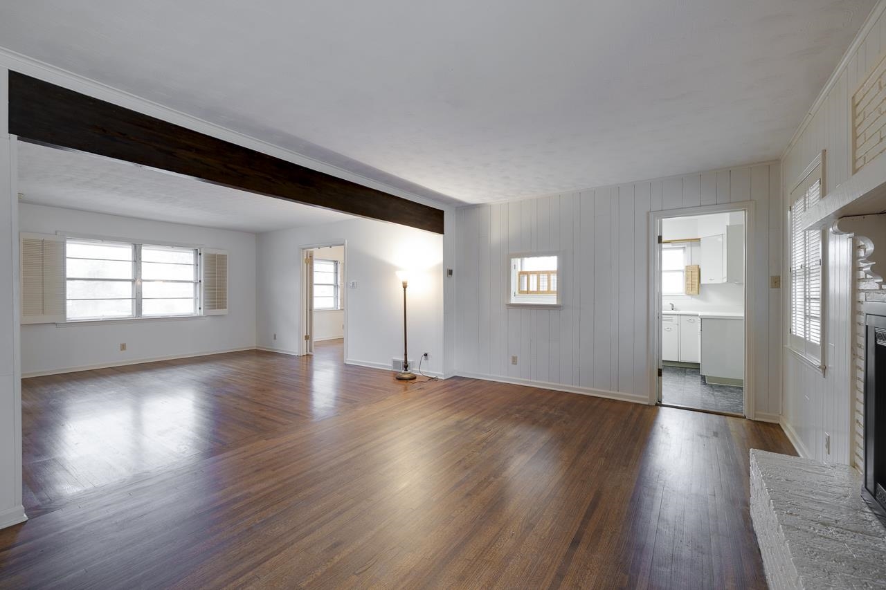 5673 Normandy Road Memphis, TN 38120 - Photo 11 of 39 an empty room with wooden floor and windows